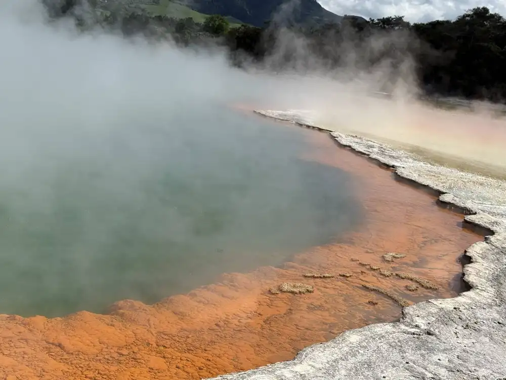 Steam rising from a colorful geothermal pool