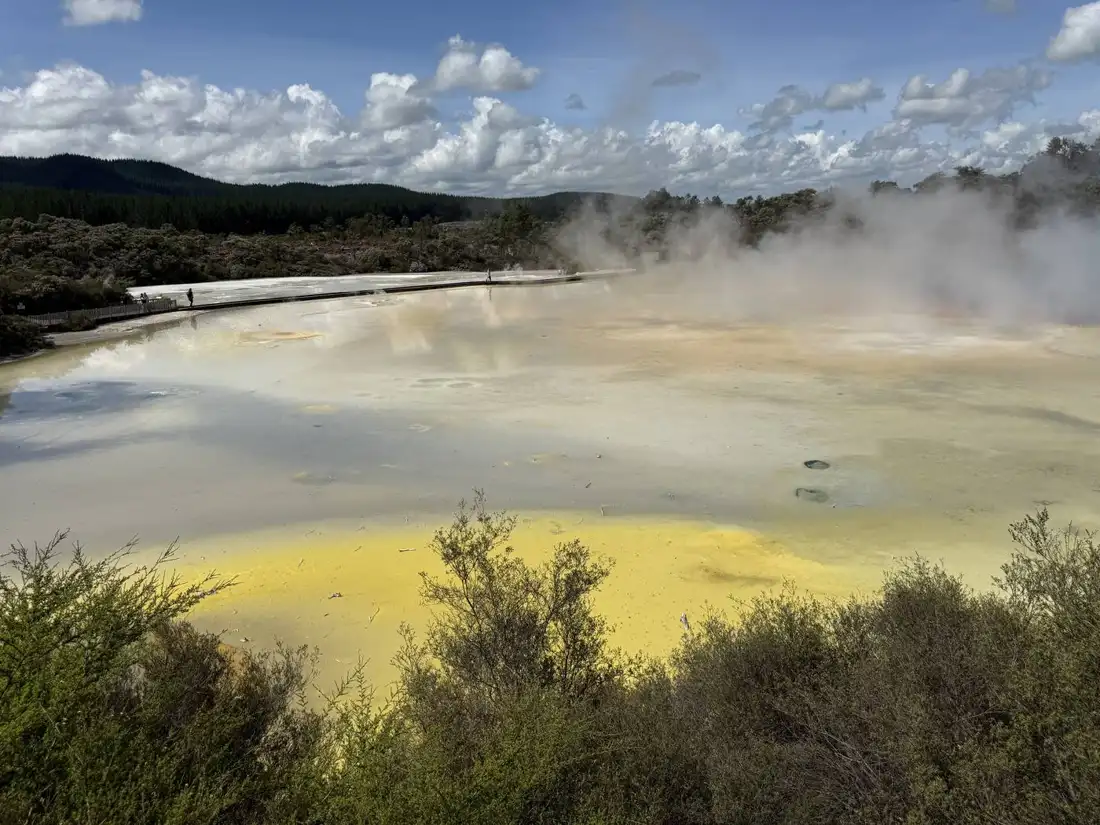 Colorful mineral pool with mountains in the distance